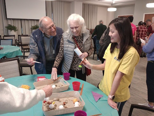FASCA members teaching residents at the Highland Springs Senior Living Community how to use chopsticks and other aspects of Taiwanese culture at their Chinese New Year celebration on Feb. 17, 2024 (Isabella Feng).