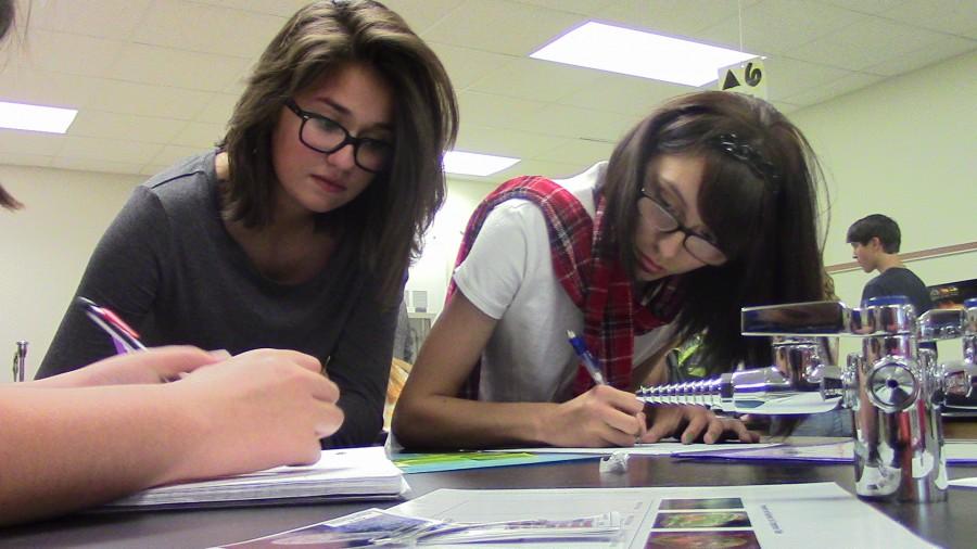 Freshmen Katrina Colley (left) and Kimberly Miller (right) finishing their biology work.