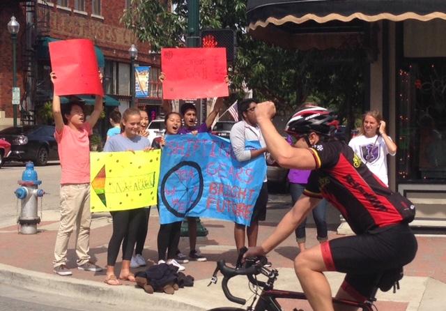 Key Club members cheer on riders as they pedal through Wish 100 Bicycle Rally course in Mckinney. 