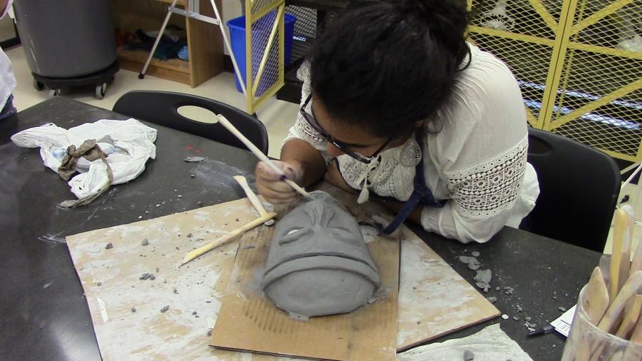 Lua Akhtarkhavari starting her new art project of mask making in ceramics. 