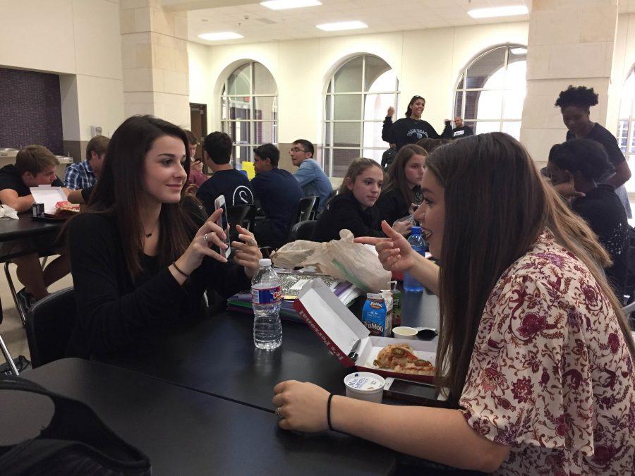 Grace Bacino and Sarah Melton eat their lunch together along with other Royals.