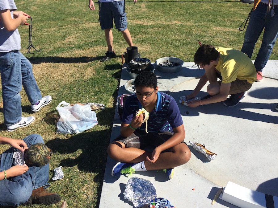 Outdoor Education students enjoy cooking on a Dutch oven outside during class.