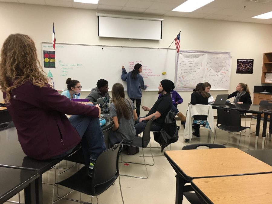 Student Ambassadors work on one of their upcoming presentations to show during activity period. While doing this they're discussing issues and what they feel is important to put in it.
