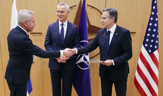 Pekka Havisto (left), Finnish Foreign affairs minister, shakes hands with Anthony Blinken (right), Secretary of State, with Jens Stoltenberg, Secretary-General, in the middle, on April 4, 2023 at NATO headquarters in Brussels. 