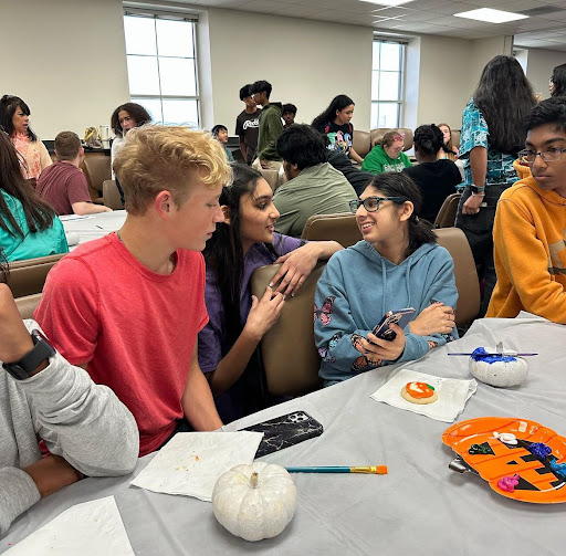 Students at the pumpkin party on Oct. 24, painting pumpkins and forming connections in the flex lab (Knight Buddies Instagram). 
